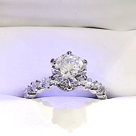 18kt White Gold Engagement Ring with 2.8 carat lab diamond at the center (Color: E | Clarity: VVS2 | Round Cut) and lab-grown DE / VVS1 grade Setting Diamonds. 6 Prongs With a Diamond Collar and 1.2 Carats of Diamonds scallop set on the shank.